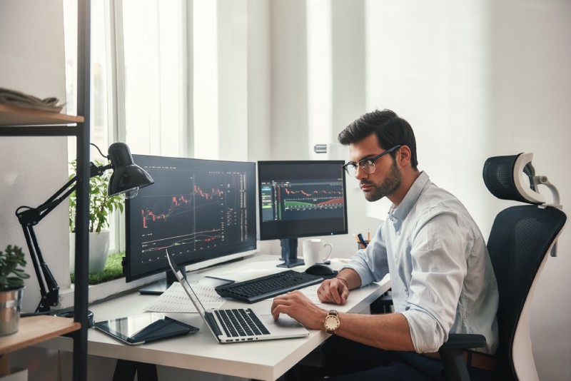 Young forex trader at their desk
