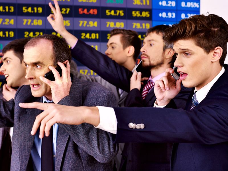 Multiple traders talking on their mobiles