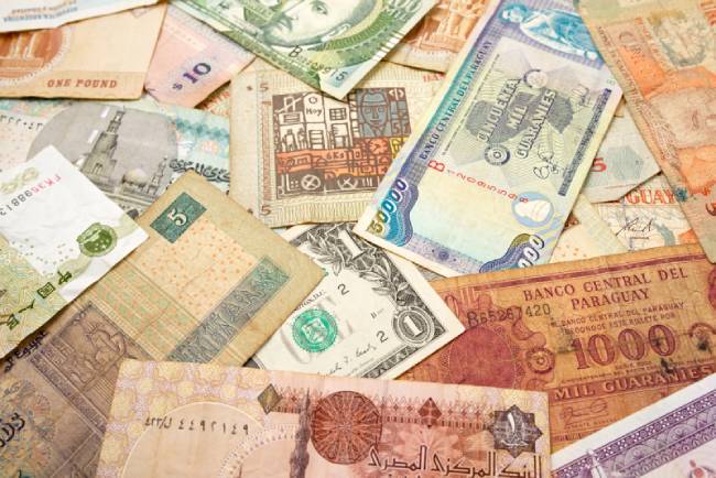 Exotic currency notes scattered on table